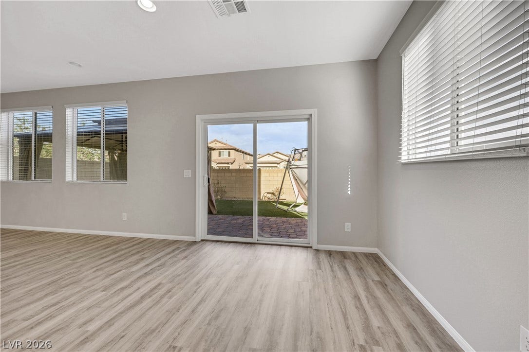 Sliding glass doors open from the living space to the backyard patio.
