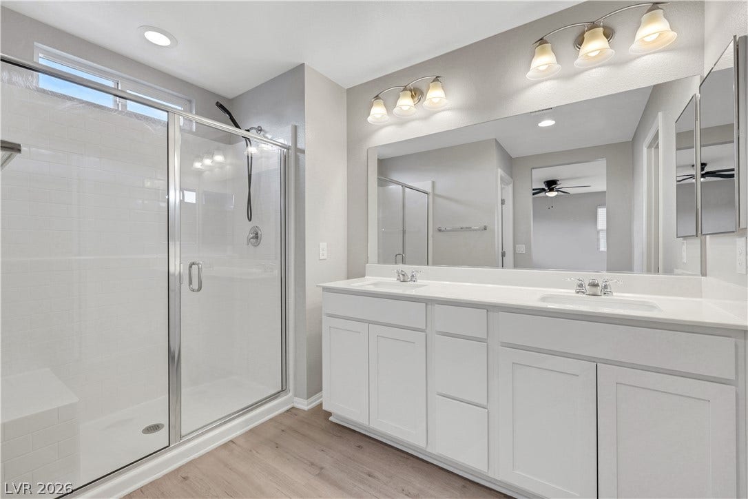 Clean lines and a spacious dual vanity define this modern, light-filled primary bath.