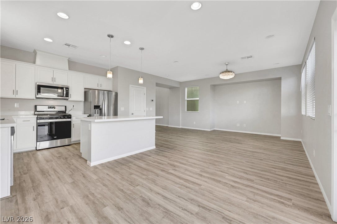 An open floorplan seamlessly connects the modern kitchen and living space.