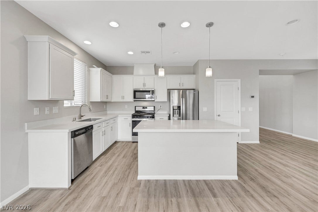 Clean lines and a spacious island define this modern kitchen with seamless open-floorplan flow.