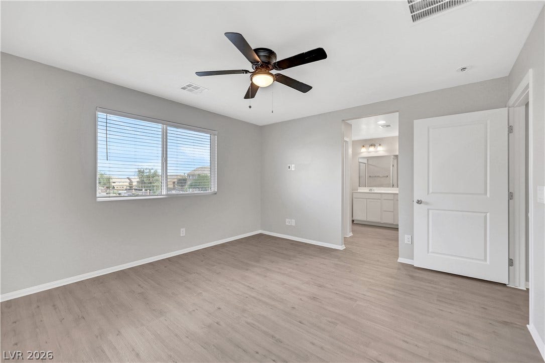 Smooth vinyl plank flooring and multiple windows create a clean, airy feel.