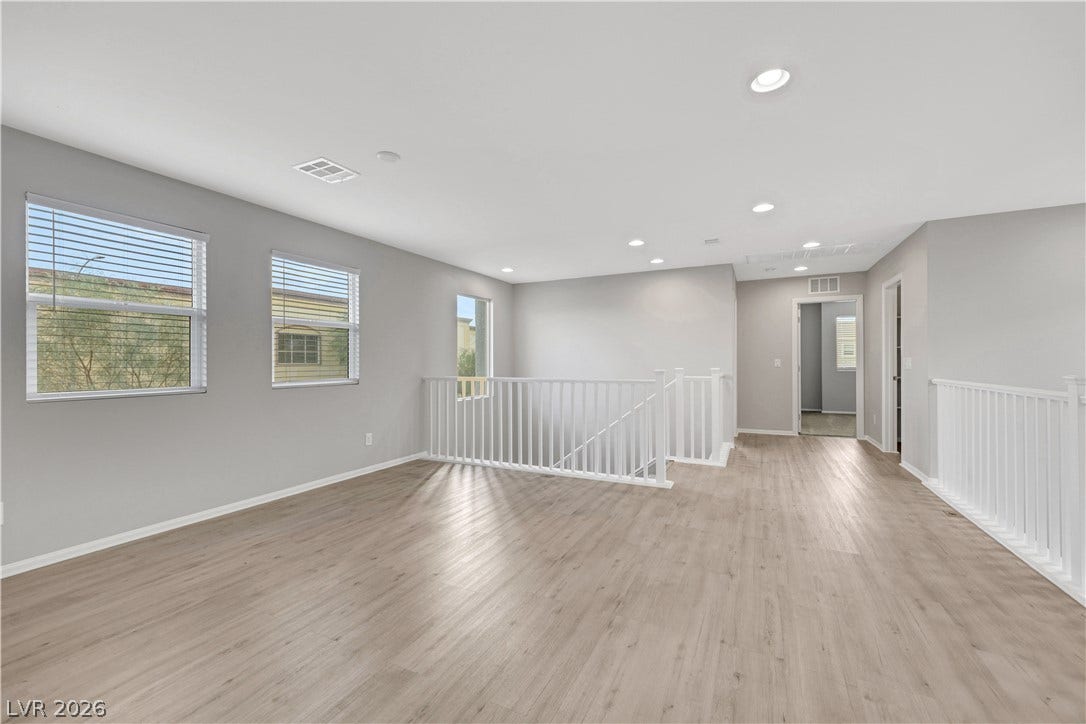 Upstairs Spacious Loft with natural lighting and smooth vinyl plank flooring.