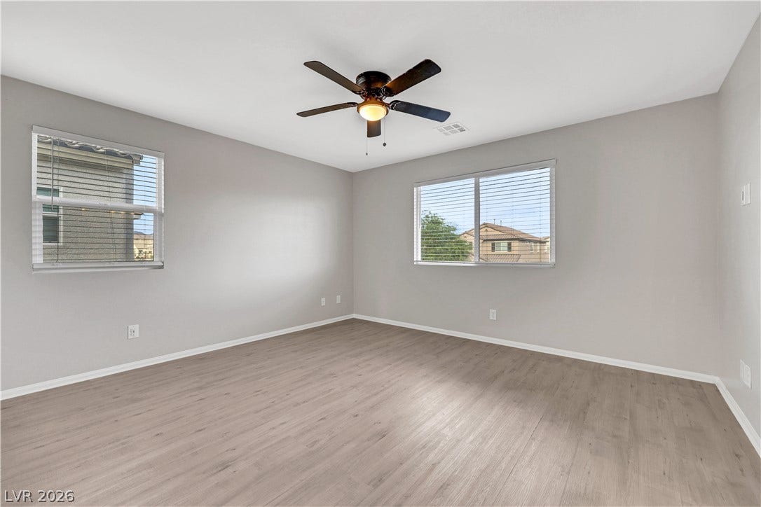Smooth vinyl plank flooring and multiple windows create a clean, airy feel.