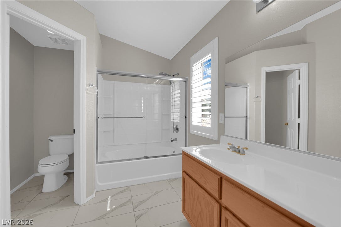 1158 Ekalaka Road, Henderson, NV 89052 High vaulted ceilings and tile flooring enhance this master bathroom with a large vanity.