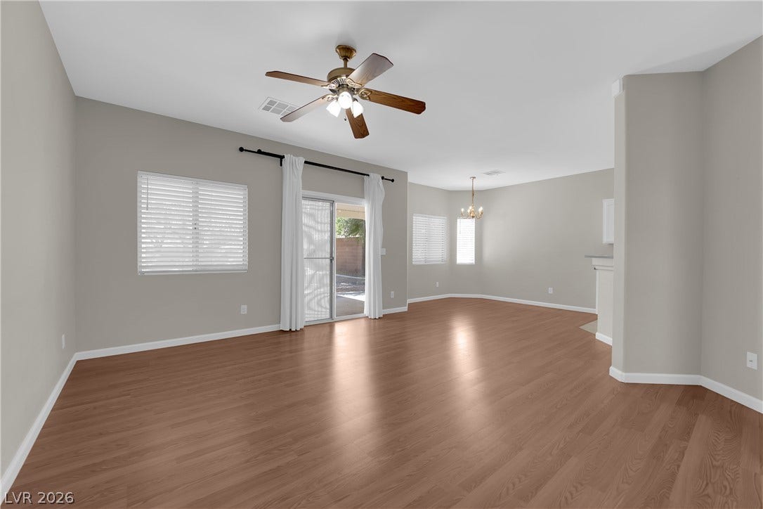 1158 Ekalaka Road, Henderson, NV 89052 Smooth wood floors and sliding glass doors define this open-concept main living space.