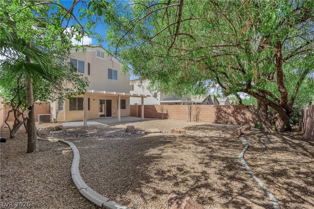 1158 Ekalaka Road, Henderson, NV 89052 Mature trees shade a low-maintenance gravel yard with a covered patio.