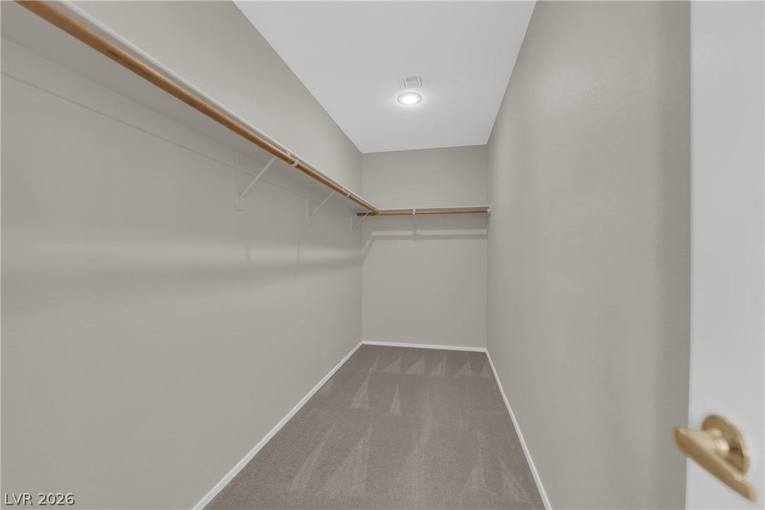 1158 Ekalaka Road, Henderson, NV 89052 Ample hanging rods and soft carpeting define this functional walk-in closet space.