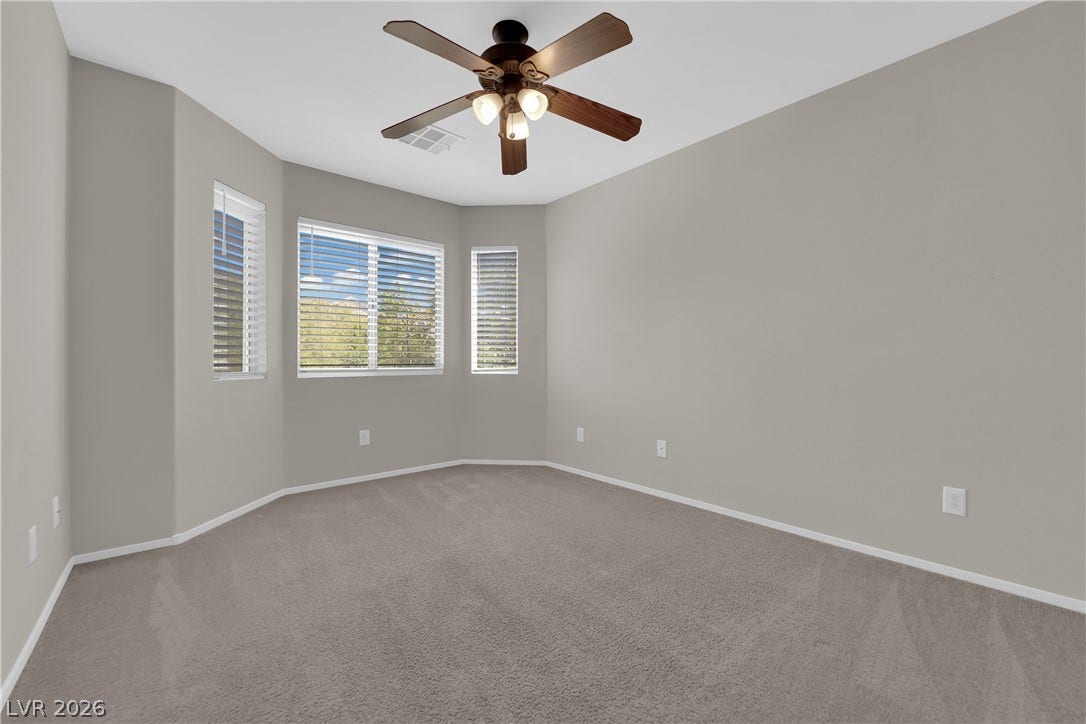 1158 Ekalaka Road, Henderson, NV 89052 Plush carpeted flooring anchors this versatile bedroom featuring a bay window configuration.