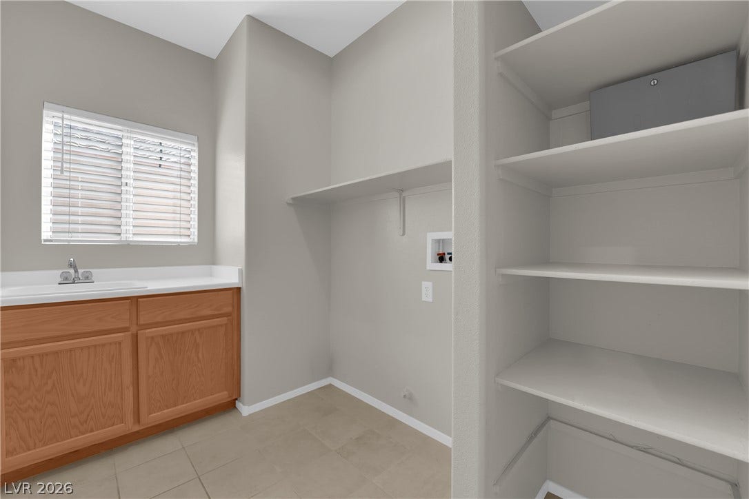 1158 Ekalaka Road, Henderson, NV 89052 Functional tile flooring and abundant built-in shelving anchor this utility space.