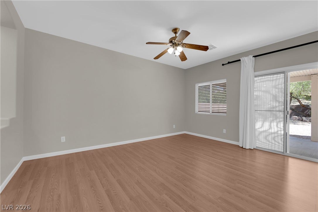 1158 Ekalaka Road, Henderson, NV 89052 Warm wood-style flooring complements the clean lines of this open living space.