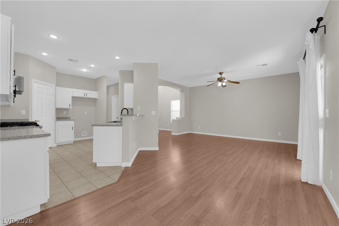 1158 Ekalaka Road, Henderson, NV 89052 Polished wood floors flow seamlessly through this airy, open-concept living space and adjacent kitchen.
