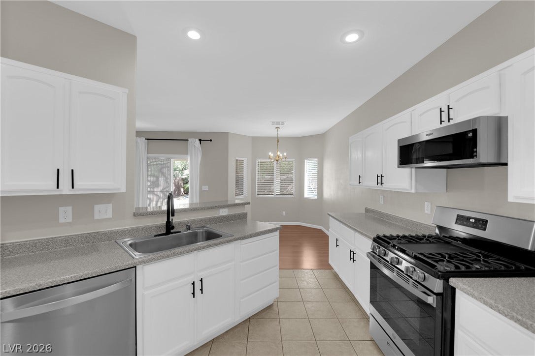 1158 Ekalaka Road, Henderson, NV 89052 Recessed lighting and stone counters highlight this functional, open-concept culinary workspace.