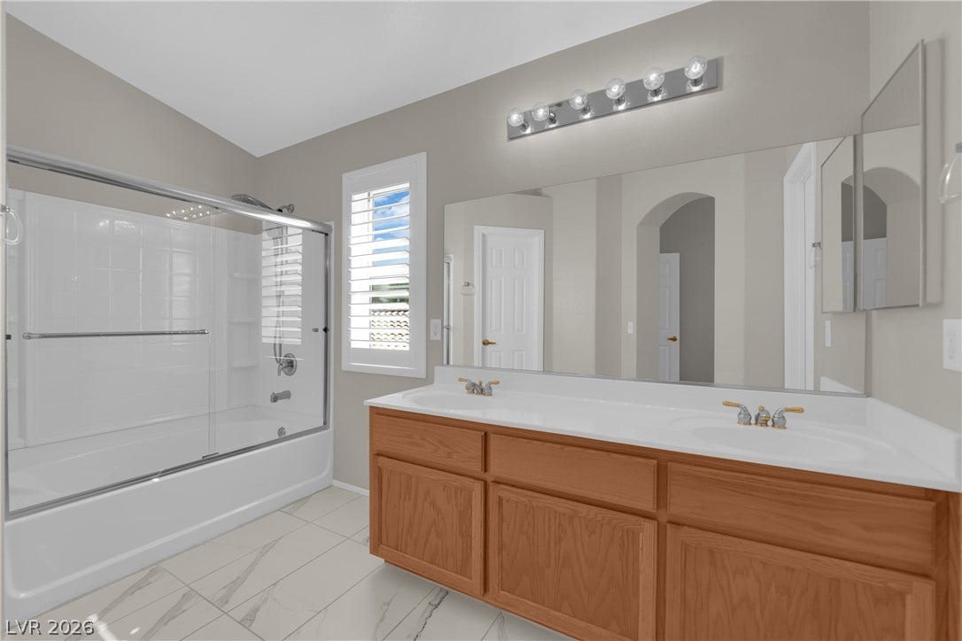 1158 Ekalaka Road, Henderson, NV 89052 A spacious double vanity and custom tile flooring define this updated bathroom layout.