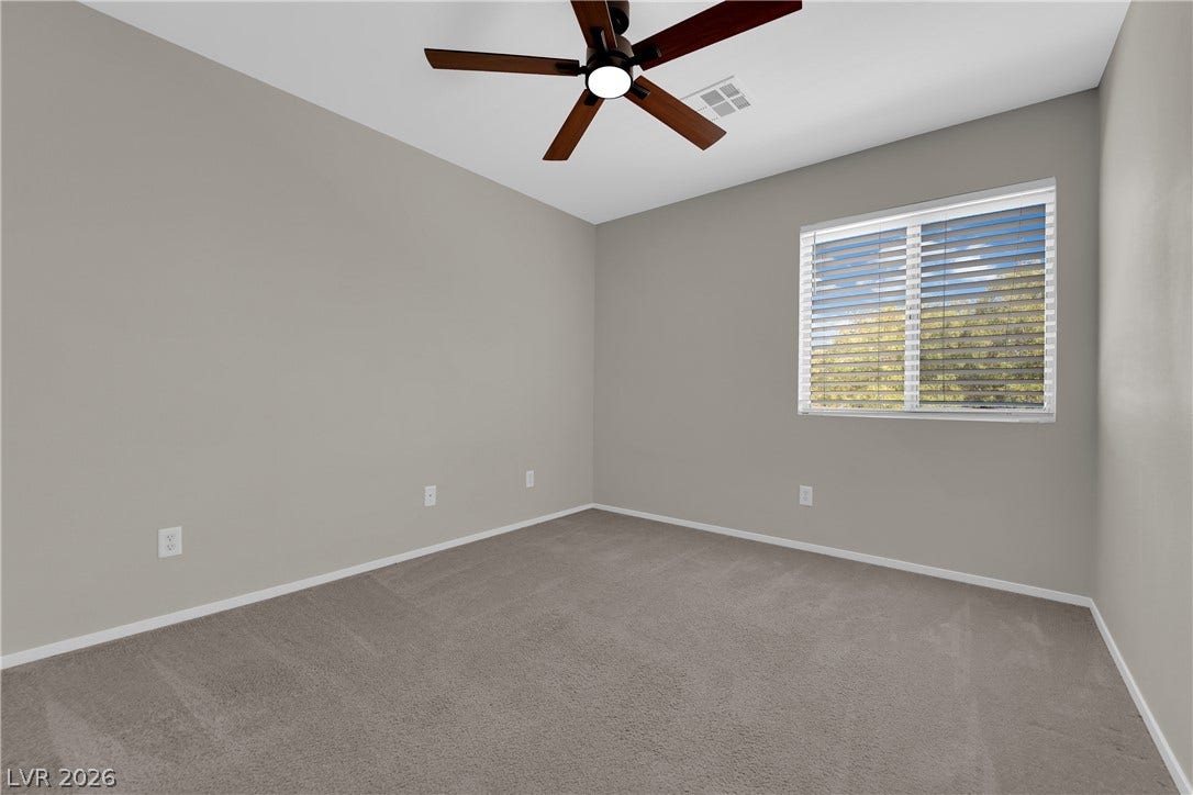 1158 Ekalaka Road, Henderson, NV 89052 A window brings natural light into this bedroom featuring soft carpeting.