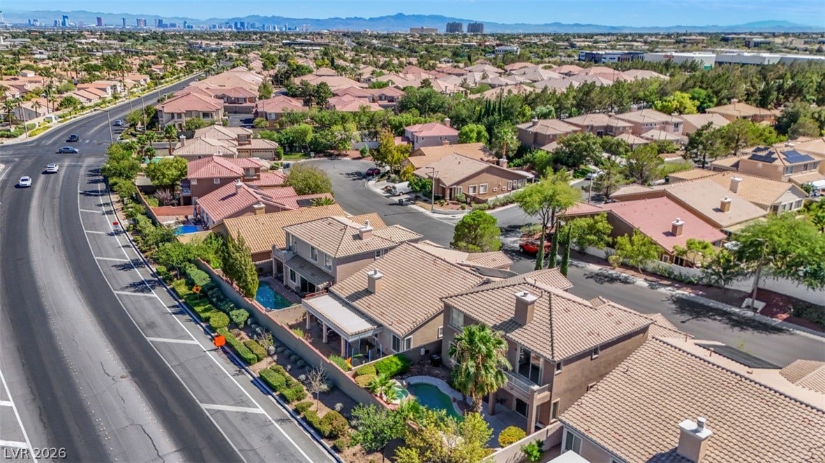 Sun-drenched tile roofs and sparkling backyard pools define this peaceful suburban neighborhood scene.