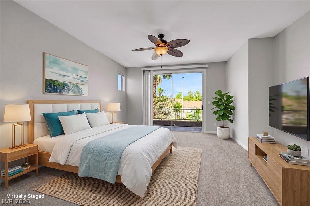 Sliding glass doors open directly to a private balcony overlooking the neighborhood.