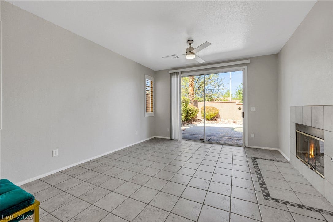 Tiled flooring and a classic fireplace anchor this inviting living space.