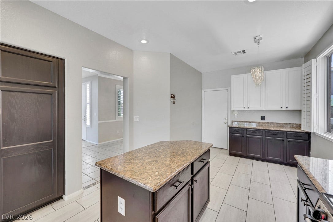 Granite counters and a central island ground this versatile kitchen space.