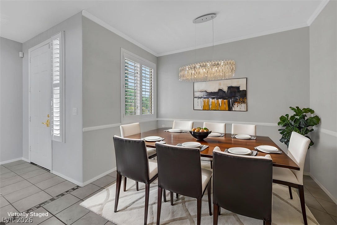 Tiled floors and elegant crown molding define this formal dining space.