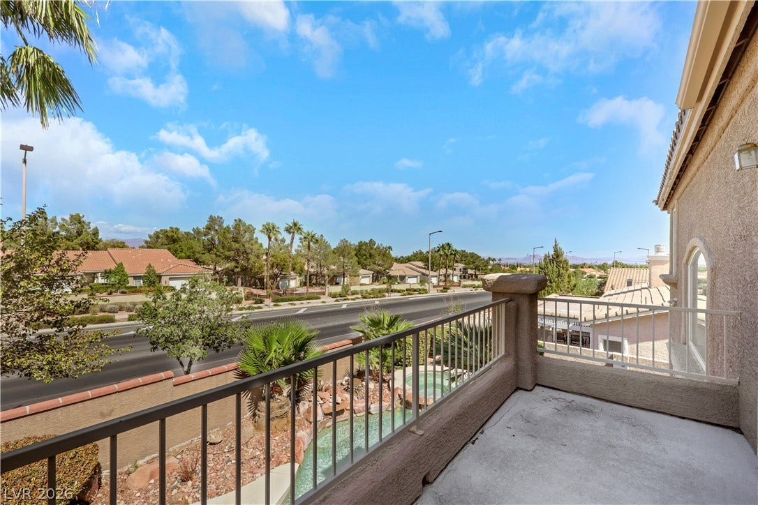 Scenic neighborhood and mountain vistas unfold from this private elevated concrete balcony.