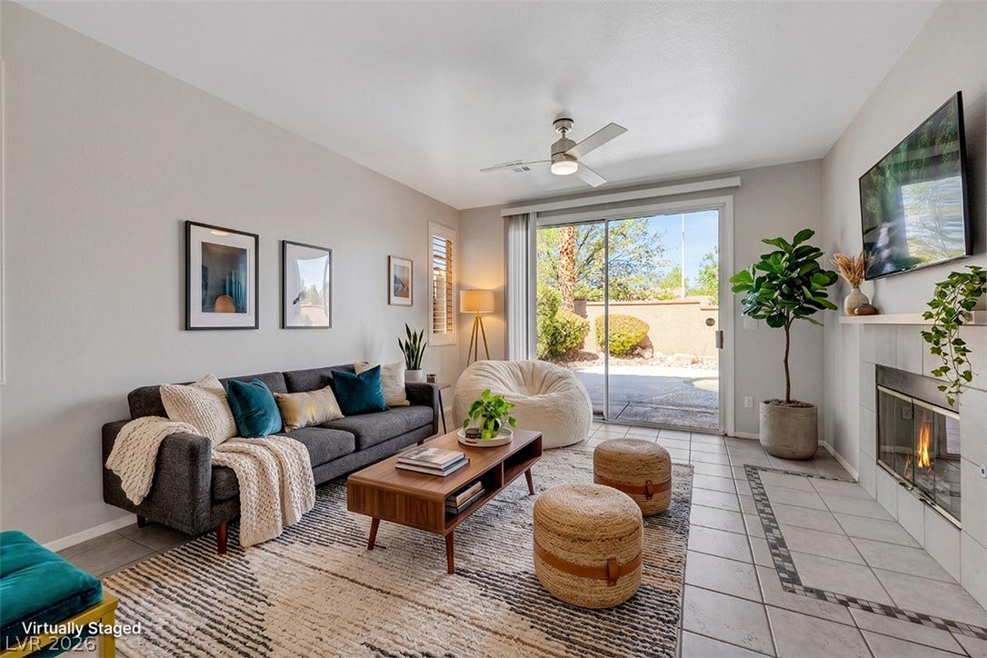 Sliding glass doors connect the tiled living area to a sunny outdoor patio.