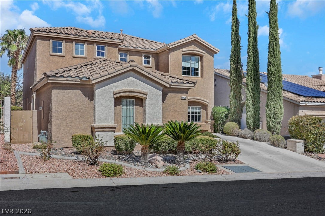 Mediterranean architectural details and desert-inspired landscaping define this handsome multi-level residence.