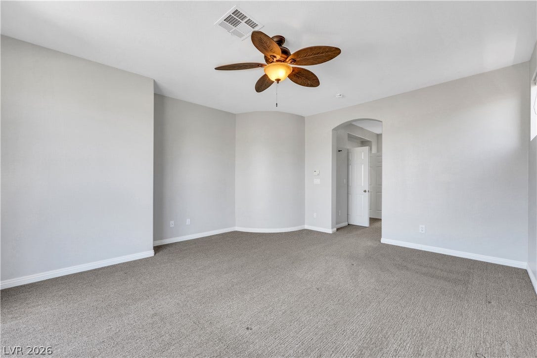 Smooth plaster walls and neutral carpeting define this comfortable, versatile living space.