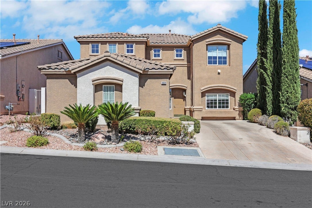 Mediterranean-inspired architecture highlights this multi-level exterior framed by sculpted desert landscaping.