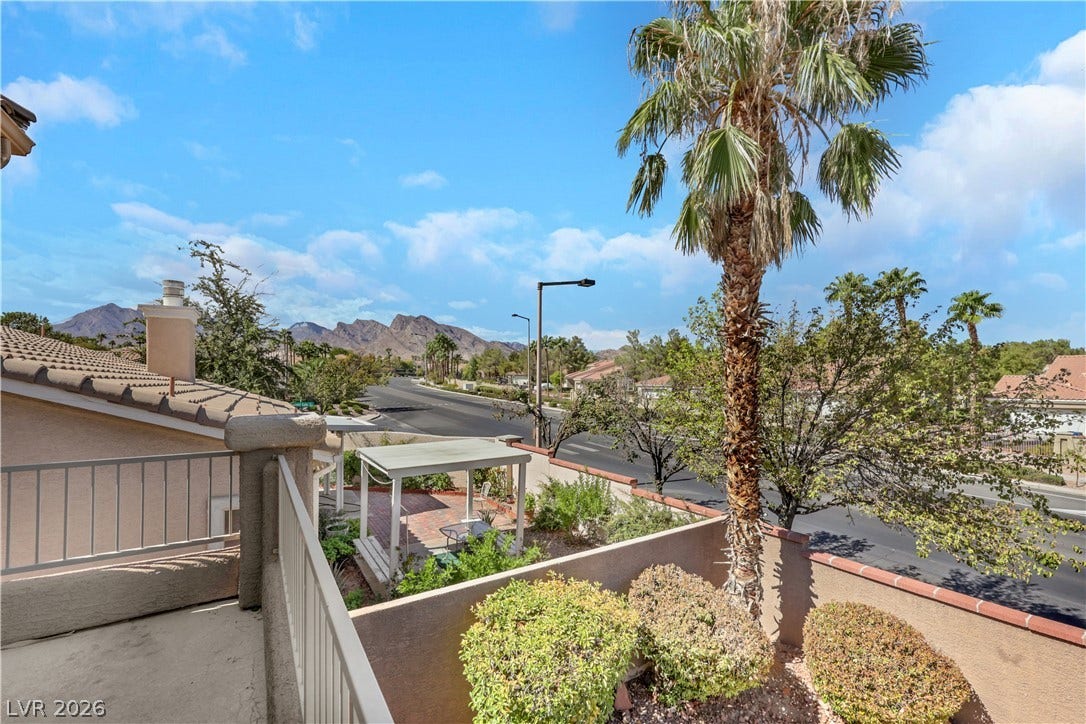 Distant mountain ridges frame the view from this elevated balcony overlooking the neighborhood.