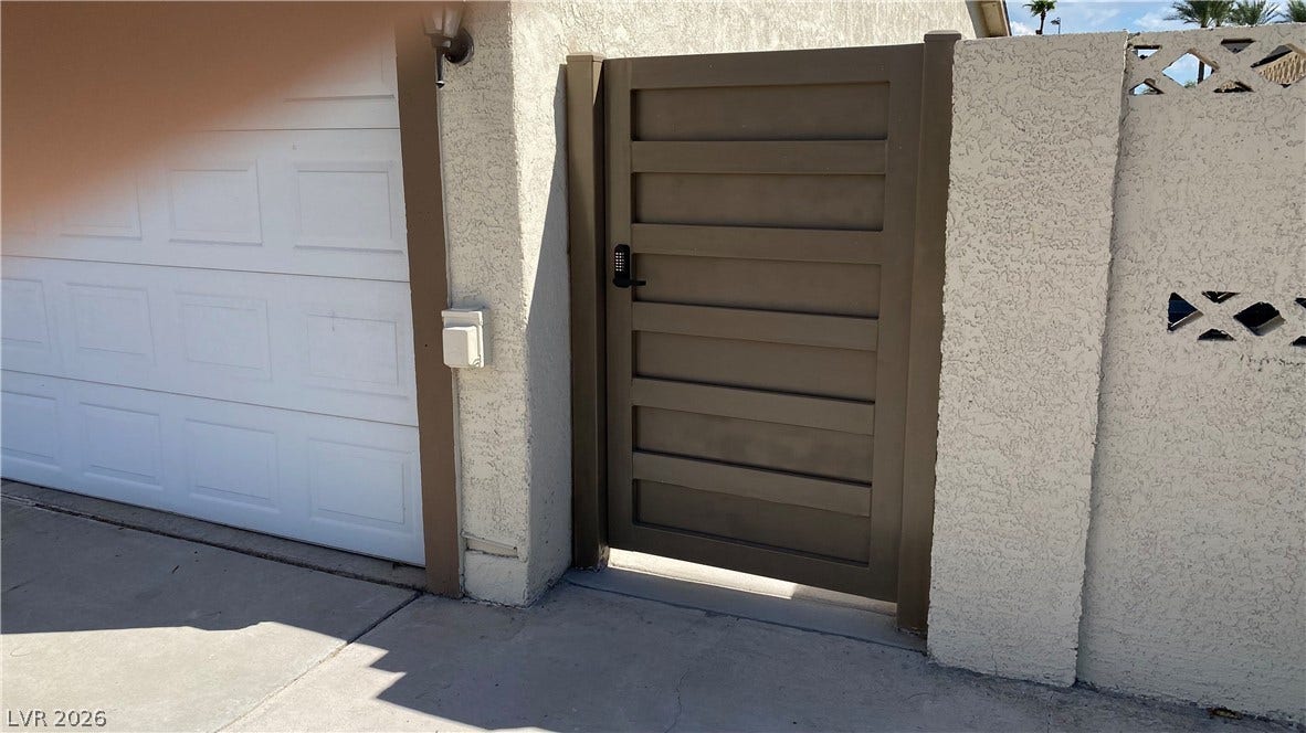 Las Vegas, NV 89119 Secure entry gate and garage access set within durable stucco walls.