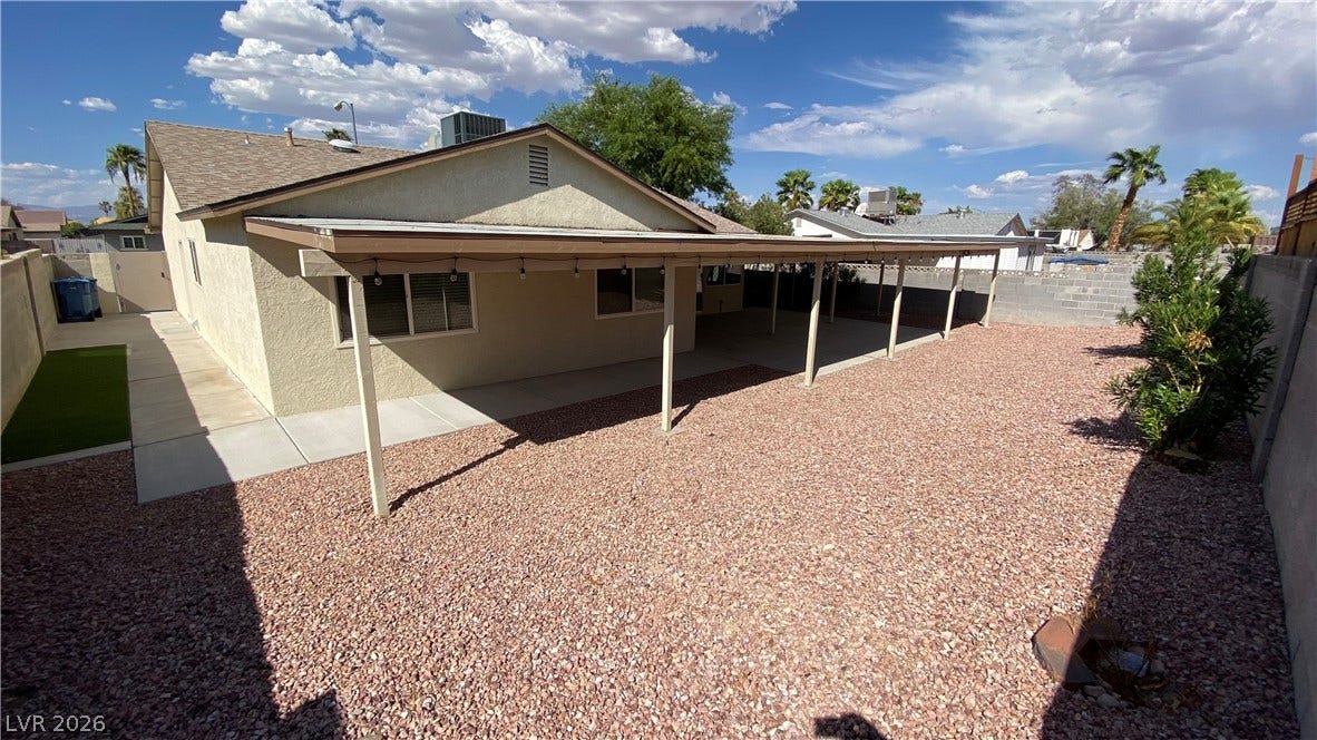 Las Vegas, NV 89119 A spacious covered patio spans the back of this stucco home with desert landscaping.