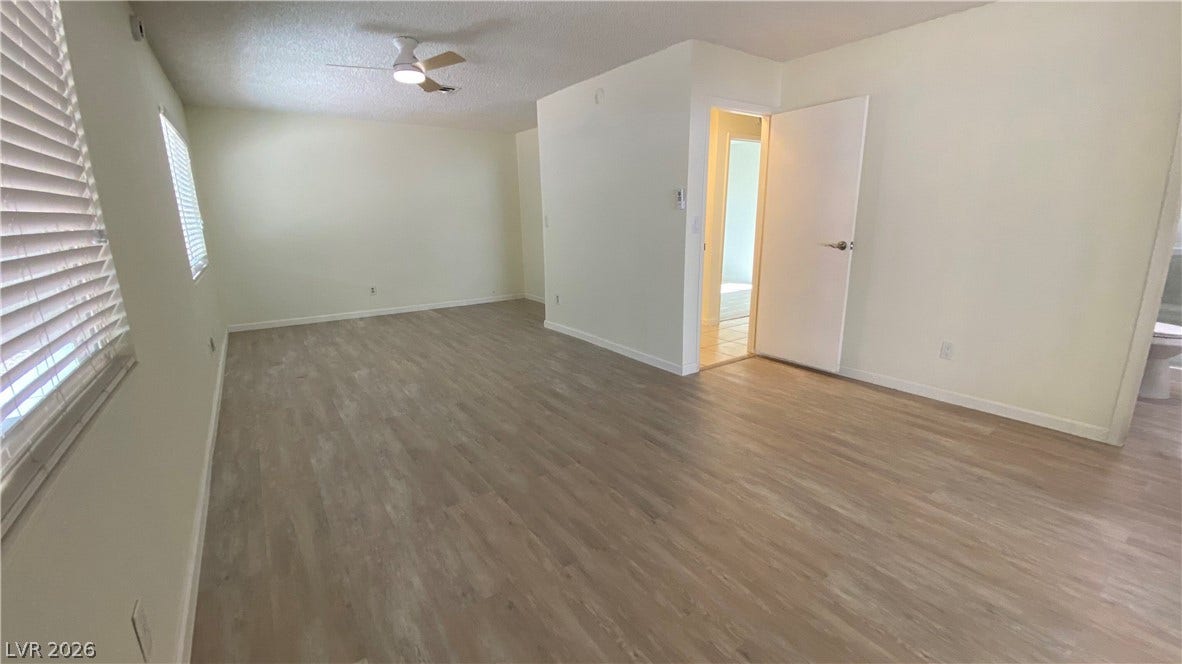 Las Vegas, NV 89119 Smooth wood-look flooring and clean lines define this versatile open living space.