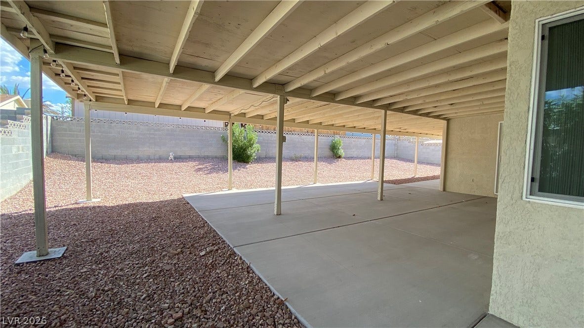Las Vegas, NV 89119 An expansive covered concrete patio overlooks the low-maintenance gravel backyard enclosed by privacy walls.