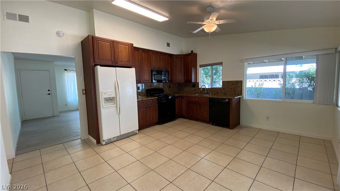 Las Vegas, NV 89119 Rich wood cabinetry contrasts beautifully with ceramic tile flooring in this classic kitchen layout.