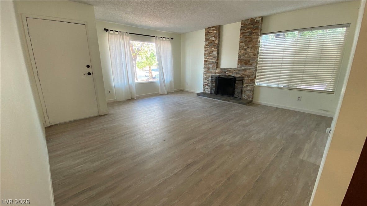 Las Vegas, NV 89119 A stone fireplace anchors the open living space, highlighted by resilient wood-look flooring.
