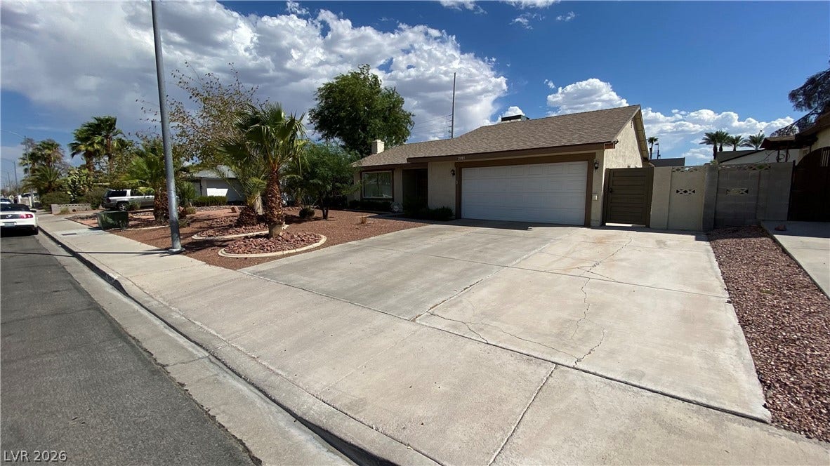 Las Vegas, NV 89119 A spacious concrete driveway leads to the attached two-car garage of this single-story residence.