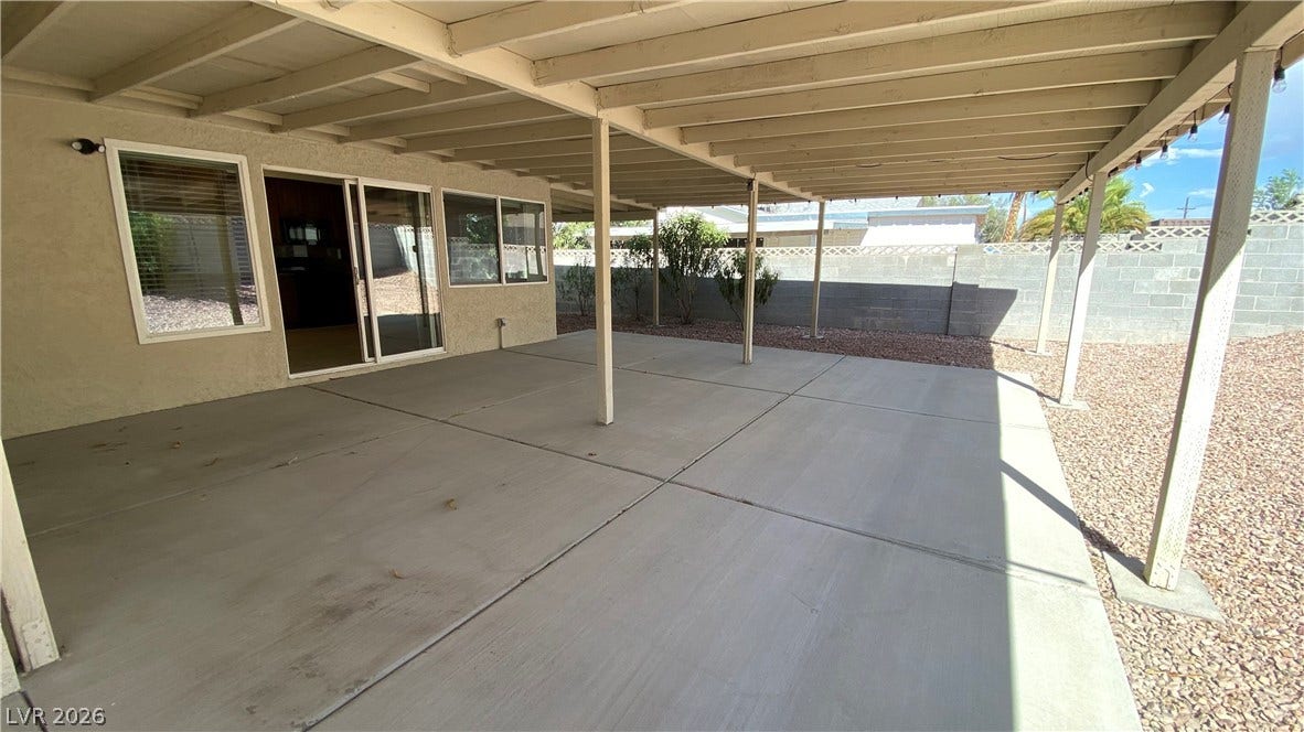 Las Vegas, NV 89119 A spacious covered patio with concrete flooring overlooks the private gravel yard.