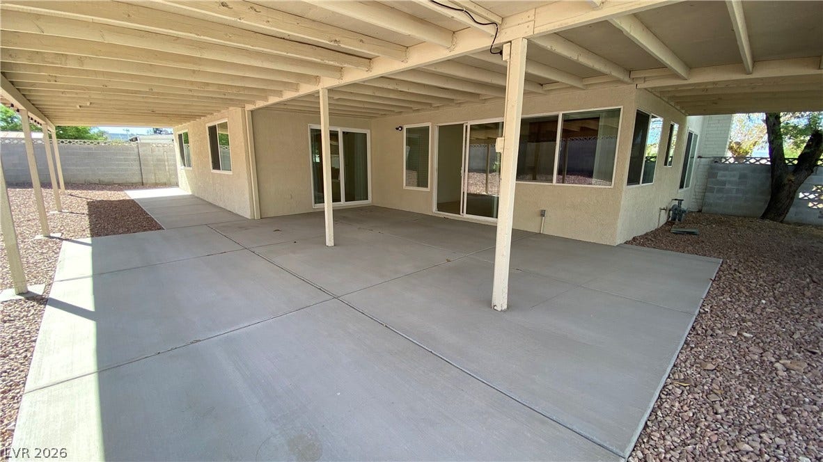 Las Vegas, NV 89119 A spacious covered concrete patio provides abundant shade alongside sliding glass doors.