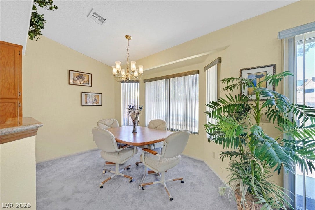 805 Stillwater Lane, Henderson, NV 89014 An inviting dining space with soft natural light, high ceilings, and adjacent sliding glass door.