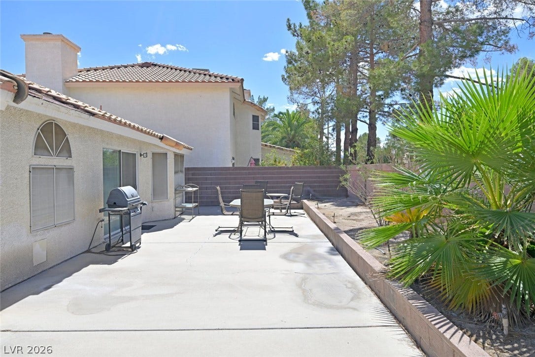 805 Stillwater Lane, Henderson, NV 89014 Patio offers a versatile outdoor area alongside mature desert landscaping.