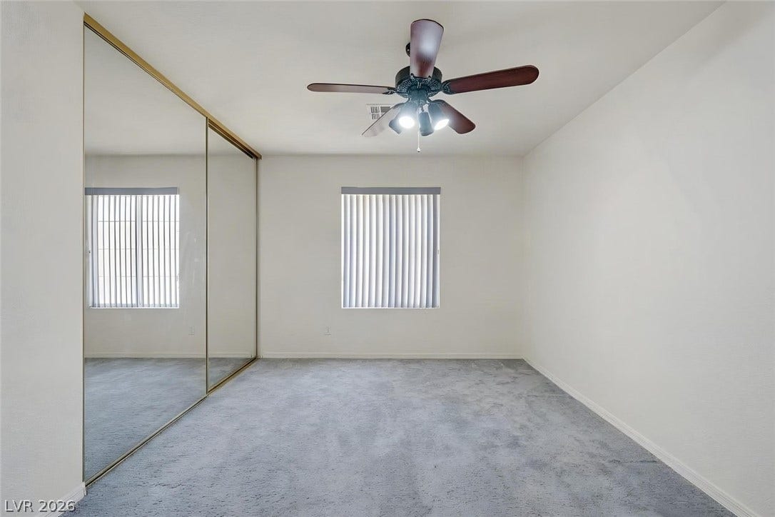 805 Stillwater Lane, Henderson, NV 89014 Carpeting and mirrored sliding doors define this functional bedroom space. **AI Generated - removed furniture - Currently being used as an office.
