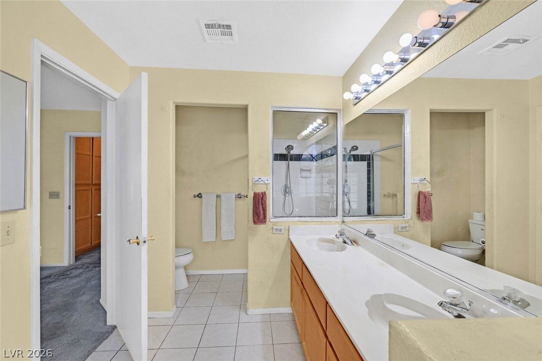 805 Stillwater Lane, Henderson, NV 89014 A spacious bathroom features dual sinks, separate shower and clean tile flooring.