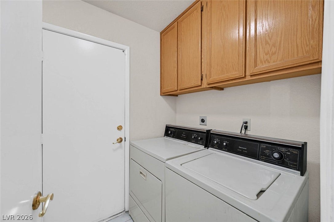 805 Stillwater Lane, Henderson, NV 89014 Ample wooden cabinetry provides convenient storage space above the in-home laundry appliances.