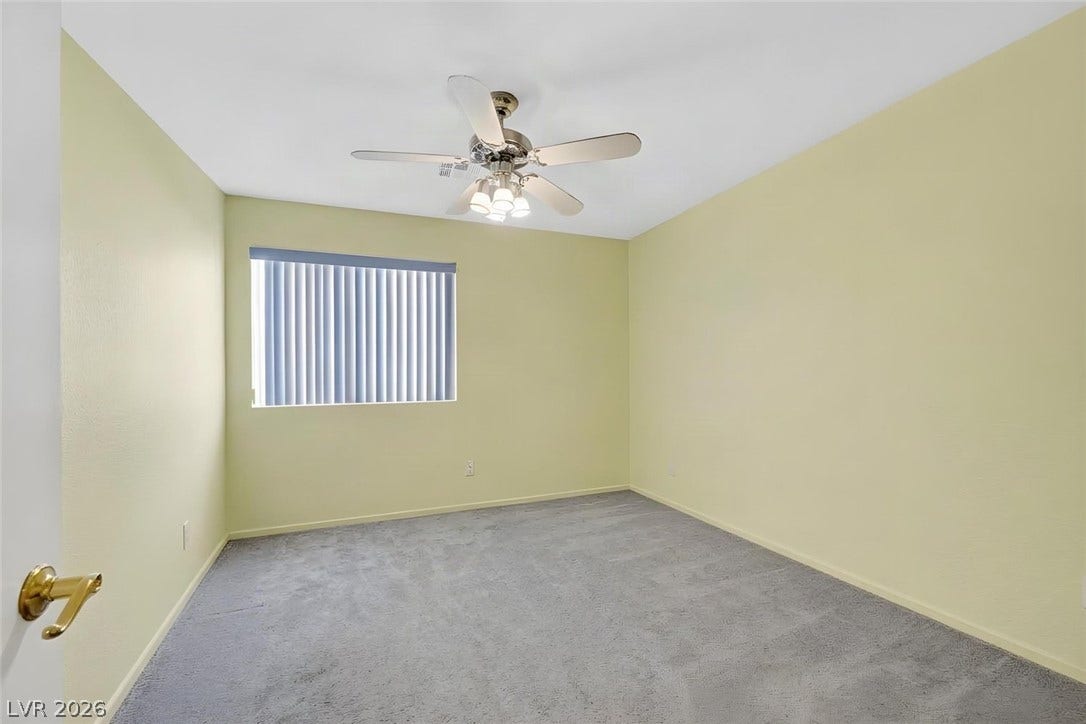 805 Stillwater Lane, Henderson, NV 89014 Plush wall-to-wall carpeting and a wide window define this comfortable secondary bedroom. **AI generated - removed furniture. Currently a guest bedroom.