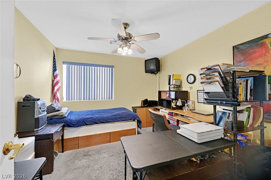 805 Stillwater Lane, Henderson, NV 89014 A versatile bedroom space features wall-to-wall carpeting and a wide window that welcomes natural light.