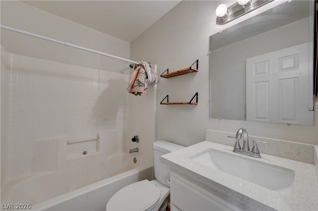 2025 Hollow Oak Avenue, North Las Vegas, NV 89031 Clean lines and stone counters highlight this functional bathroom space.