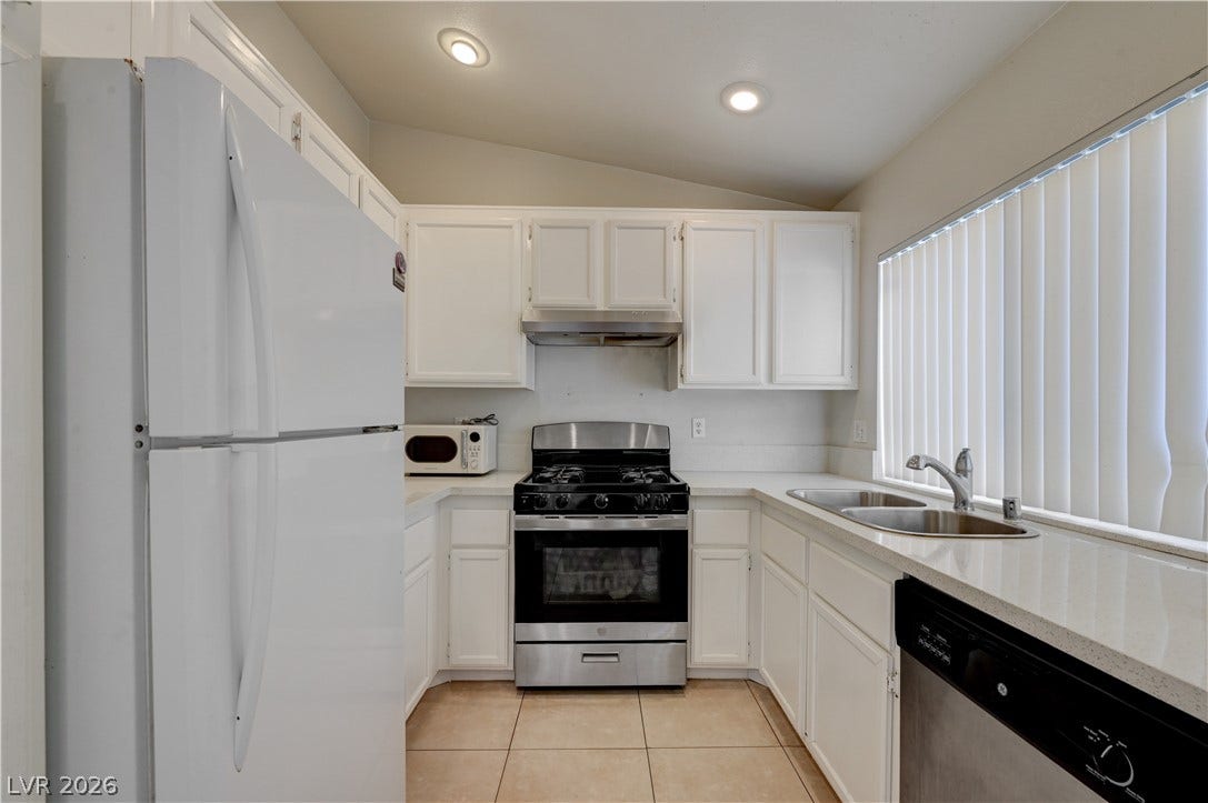 2025 Hollow Oak Avenue, North Las Vegas, NV 89031 Gleaming counters and tile flooring accent this efficiently designed cooking space.