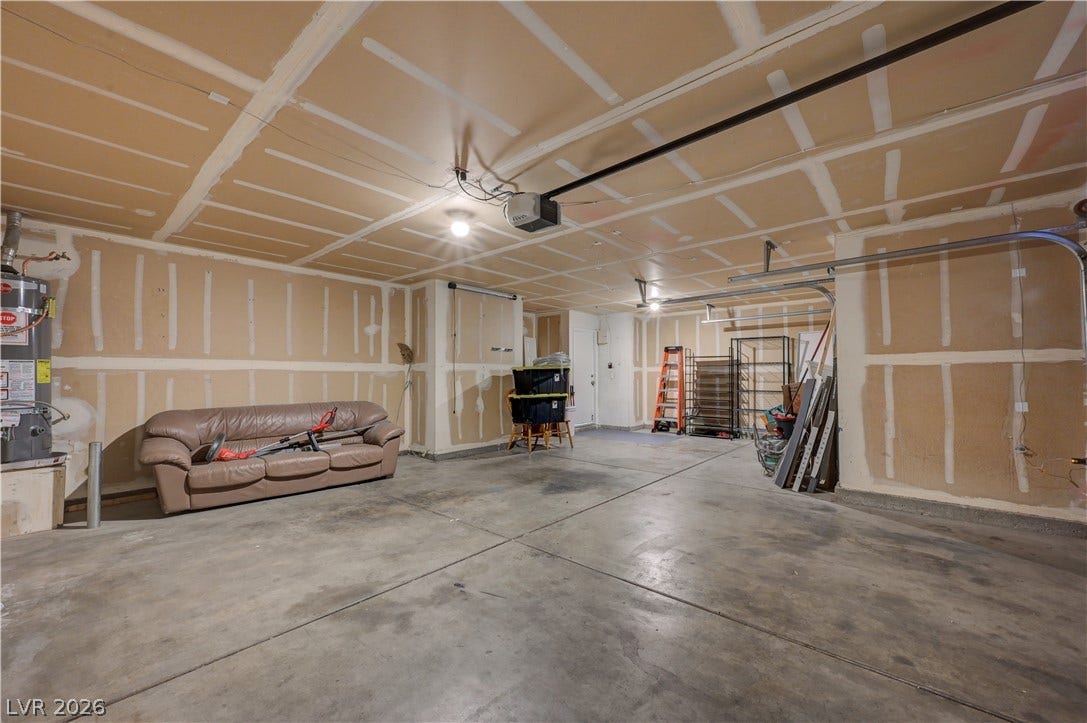 2025 Hollow Oak Avenue, North Las Vegas, NV 89031 Concrete floors and generous ceiling clearance anchor this adaptable multi-car garage space.