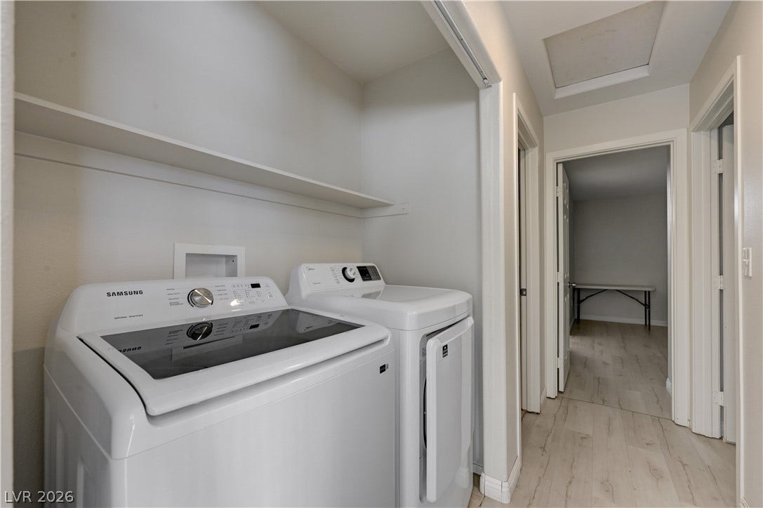 2025 Hollow Oak Avenue, North Las Vegas, NV 89031 A hallway laundry closet provides built-in shelving above the included appliances.