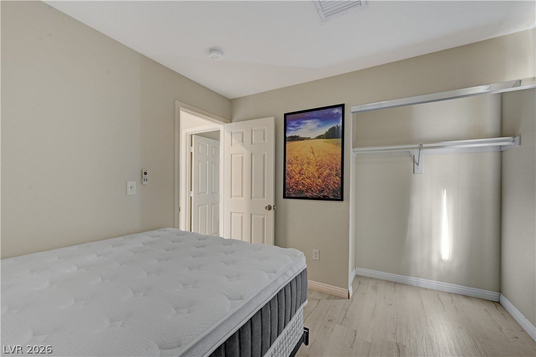 2025 Hollow Oak Avenue, North Las Vegas, NV 89031 Smooth wood floors and crisp neutral finishes define this versatile bedroom with generous closet space.